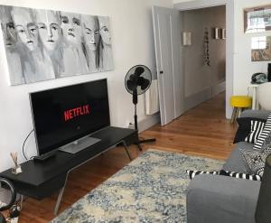 a living room with a flat screen tv on a table at Casa Santa Luzia - Historic Centre in Guimarães