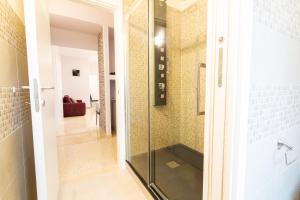 a glass shower in a bathroom with a hallway at Sorrento's House in Sant'Agnello