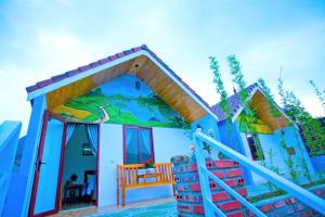 a small house with a blue at Phong Nha Friendly Home in Phong Nha