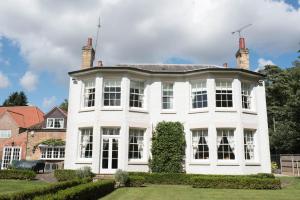 a large white house with a yard at The Old Parsonage in Brigg