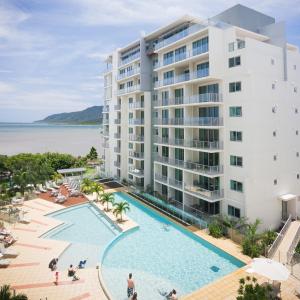 
a beach with a pool and a large building at Mantra Trilogy in Cairns
