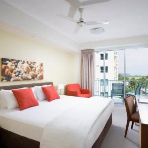 
a hotel room with a large bed and a large window at Mantra Trilogy in Cairns
