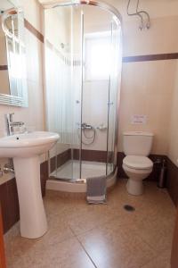 a bathroom with a shower and a toilet and a sink at Iliothea in Nafplio +37 photos