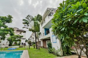 a view of a building with a pool and trees at Villa Samaara14 Candolim Beach 500mts in Candolim