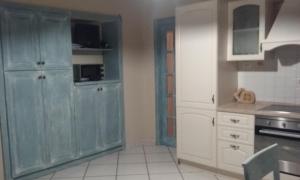 a kitchen with blue cabinets and white appliances at La casina di Silverio in Rio Marina