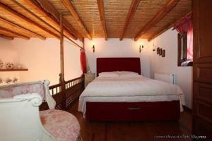 a bedroom with a bed and a chair in it at Traditional studio in Skiros
