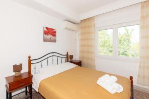 a bedroom with a bed and a window at Karagiannis in Keramoti