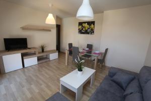 a living room with a couch and a table at Apartamento turisticos Puente Romano P3 2-A in Salamanca