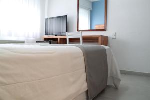 Cama ou camas em um quarto em Hotel Florinda