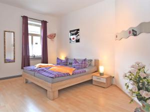 a bedroom with a bed and a couch in it at Spacious Apartment in Ballenstedt Harz near Lake in Ballenstedt