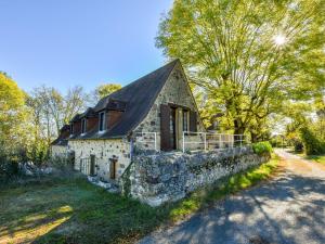 an old stone house with a black roof at Holiday home with swimming pool in Saint-Laurent-la-Vallée