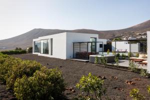 a modern house with a view of the mountains at ICONIC VILLA LANZAROTE in Mácher