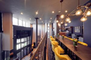 
a kitchen with a lot of tables and chairs at Malmaison Liverpool in Liverpool
