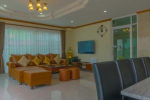 a living room with a couch and a table at Sea you pool villa Hua Hin in Hua Hin