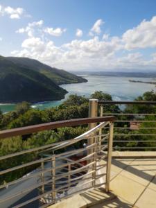 a balcony with a view of a body of water at Knysna Pearl View Guest House in Knysna