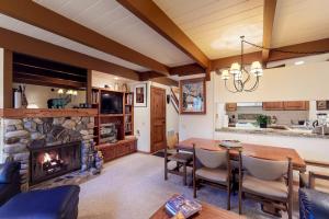 a living room with a table and a fireplace at Dollar Meadows in Sun Valley
