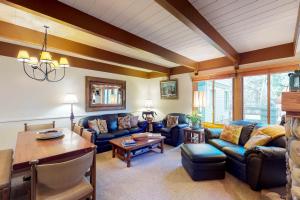 a living room with blue couches and a table at Dollar Meadows in Sun Valley