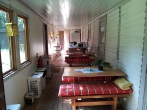 a room with several tables and benches in a house at Chokladvillan in Visby