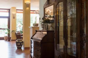 a large wooden cabinet with glass doors in a room at Relais Pian delle Starze in Marina di Camerota