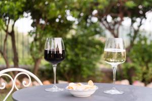 two glasses of wine and a bowl of food on a table at Hotel Relais Pian delle Starze in Marina di Camerota