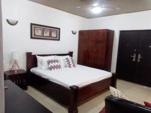 A bed or beds in a room at Likizo Guest House