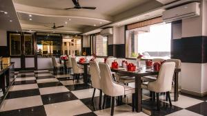 a restaurant with a checkered floor and a table and chairs at D'Polo Club & Spa Resort in Dharamshala