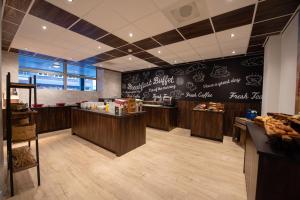 a fast food restaurant with a black chalkboard wall at Flonk Apartments Groningen Centre, voorheen Best Western Apartments Groningen Centre in Groningen