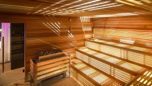 a sauna with wooden walls and wooden floors and lights at The President in Prague