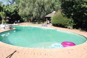 a large swimming pool with two frisbees in it at Grace Accommodation Centurion in Centurion