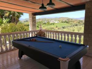 a pool table on a balcony with a view at B&B Finca La Luna Azul in Coín
