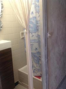 a bathroom with a shower with a shower curtain at Vista mare vecchia città in Menton