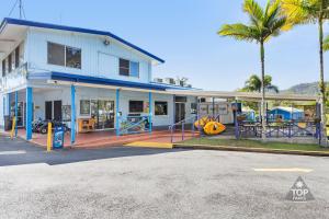 a building with a playground in front of it at Lake Tinaroo Holiday Park in Tinaroo