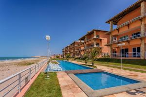 a resort with a swimming pool next to the beach at Dream Away Uruaú Beach Residences in Uruau