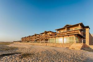 a building on the beach next to the ocean at Dream Away Uruaú Beach Residences in Uruau