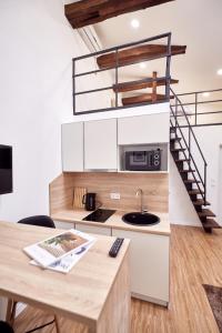 a kitchen with a spiral staircase and a table at Nordian in Kharkiv