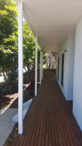 a porch of a house with a wooden deck at Island Escape in Wimbledon Heights