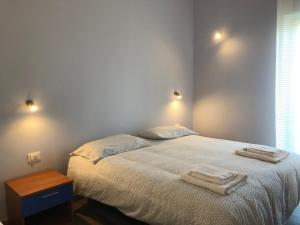 a bedroom with a bed with two towels on it at Profumo di Zagara in Corigliano Calabro