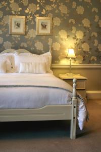 a bedroom with a bed and a table with a lamp at Rathaspeck Manor B&B in Wexford