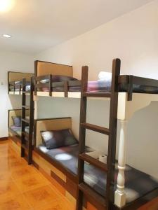 a group of bunk beds in a room at Park Vil-la Apartelle in Manila
