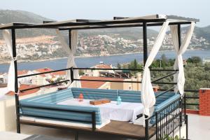 a gazebo with a table on a balcony with a view at Lizo Hotel in Kalkan