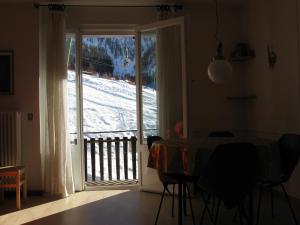 a room with a door open to a snow covered yard at Appartamenti Fronte Piste - Appartamentiflarida Foppolo in Foppolo