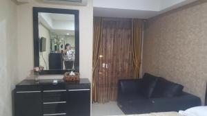 a person taking a picture in a mirror in a hotel room at Warhol Apartement Lt 15 Jl. Ahmad Yani Simpang 5 Semarang in Semarang