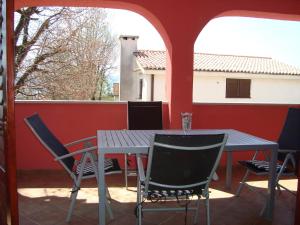 a table and chairs sitting on a balcony with a table and chairs at Apartments Josip in Pinezici