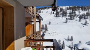 a balcony with a view of a snow covered mountain at chalet des rennes in Vars