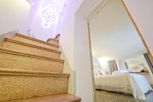 eine Treppe mit einem Spiegel neben einem Schlafzimmer in der Unterkunft L'Angolo di Ostuni - Home&Terracex4 in Ostuni