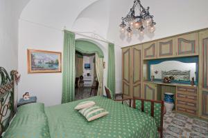 a bedroom with a bed and a painting on the wall at Casa Teresa in Positano