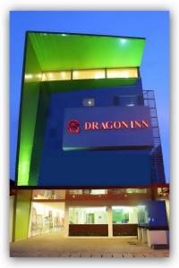 a dragon inc sign on the side of a building at Hotel DRAGON INN Kemayoran in Jakarta