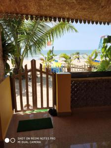 a view of the beach from the balcony of a resort at Alegro Beach Homes in Palolem