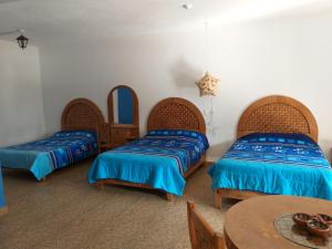 Un pat sau paturi într-o cameră la Hotel Villas Monteli Suites Cuernavaca