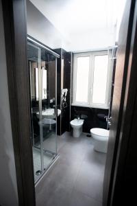ein Badezimmer mit zwei Waschbecken, einem WC und einer Dusche in der Unterkunft Amazing Napoli in Neapel